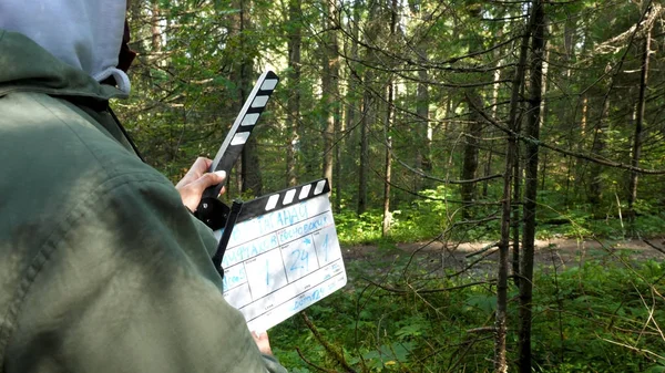 Movie clapper in forest. Clapperboard in forest. Film shooting in forest areas