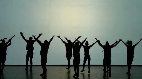 Dance of shadows. Dancers dancing on the stage. Dancers silhouettes. Dance shadows. 3D Dance show