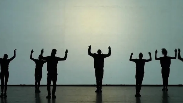 Dance of shadows. Dancers dancing on the stage. Dancers silhouettes. Dance shadows. 3D Dance show