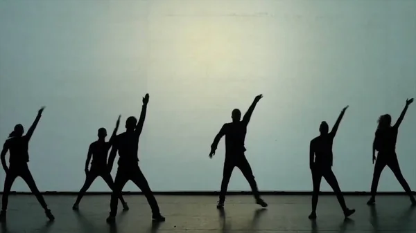 Dance of shadows. Dancers dancing on the stage. Dancers silhouettes. Dance shadows. 3D Dance show