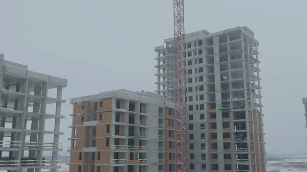 Apartments construction site with crane. Crane and building construction