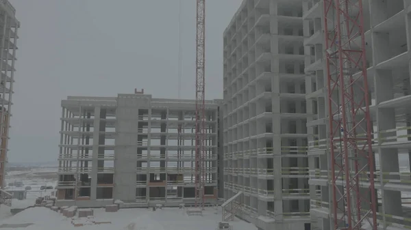Apartments construction site with crane. Crane and building construction