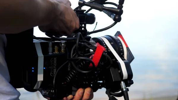 Man holding a camera filming a movie in the forest. Expensive camera for movie in the woods — Stock Photo, Image