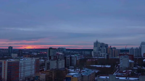 Evening city in winter timelapse. Evening city in winter view from roof timelapse. Panoramic view on the town and roofs under the snow, timelapse. Street night city lights — Stock Photo, Image