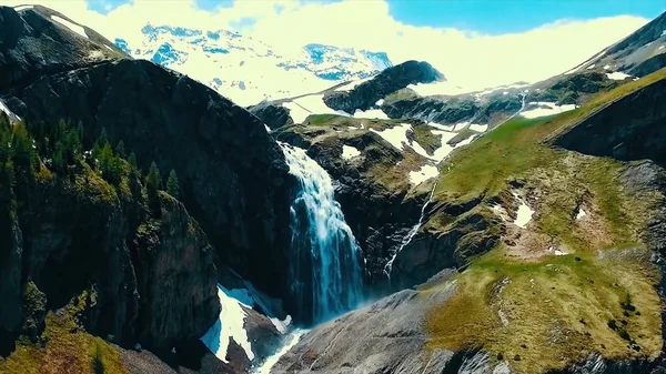 Vistas panorámicas sobre el río con agua blanca y montaña distante con alta cascada. Vista desde la cima de la cascada y las montañas nevadas — Foto de Stock