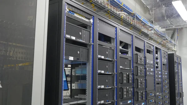 Storage servers are located in the server room of the data center. Back of the server installed in the server room. Many cables are connected to a powerful computers — Stock Photo, Image