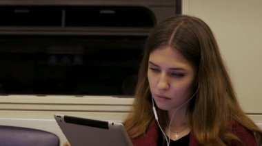 Genç işkadını seyahat tren tablet bilgisayar. Genç kadın metro tablet içinde çalışıyor