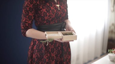 Kırmızı elbiseli bir ahşap kutu tutan kadın. Çekici kadın özel bir hediye sunuyor kırmızı giymiş. Ahşap kutu. Erkek holding ahşap kutu eller