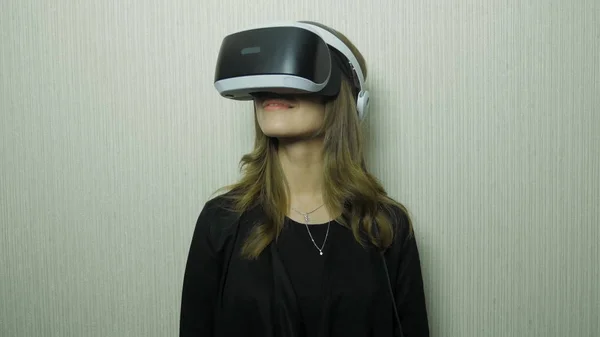 Mulher jovem experimentando óculos de realidade virtual. Jovem que gosta de usar óculos de realidade virtual em casa. Mulher em óculos VR em casa — Fotografia de Stock