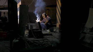 İşçi koruyucu maske kaynak metal.welding yavaş çekimde siyah arka plan ile. Koruyucu maske kaynak metal yavaş çekimde karanlık kontrast arka planda olan adam