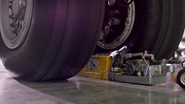 Airplane chassis close up. Front landing gear of big passenger aircraft closeup high detailed view. Chassis of the airplane under heavy maintenance. — Stock Video