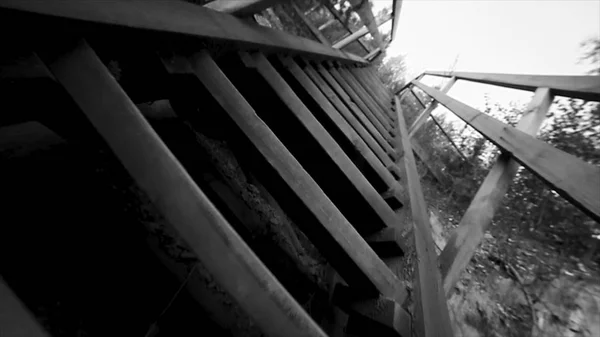 Bottom view of old stairs sky background black and white. Footage. Thai wooden house stair style. Old wooden bridge at the river — Stock Photo, Image