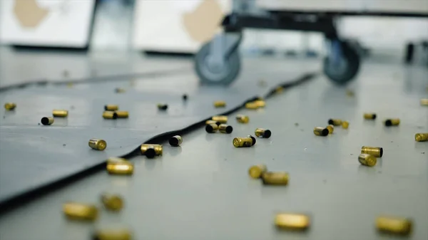 Huge number of shell casings from bullets lying on the floor in the room. Terrible shooting indoors after which there was a lot of shell casings from bullets — Stock Photo, Image