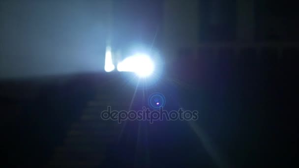 Light flare special effect. Spotlight in the camera. Spotlight shines into the camera in the theater — Stock Video