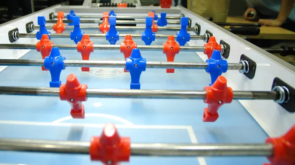 Table football soccer game kicker . Table football game, Soccer table with red and blue players. Young friends playing table football together indoors — Stock Photo, Image