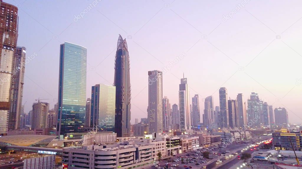 Beautiful aerial view with sky from top to sunrise and city futuristic skylines buildings and infrastructure. Dubai, United Arab Emirates. Top view of Dubai at sunrise