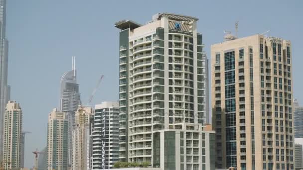 Egyesült Arab Emírségek, Dubai - 2017 október: kilátás nyílik a városra, az autó. Kilátás a belső tér az autó az utcákon Dubai, a férfi mögött a kerék az autó, egy forró napon — Stock videók