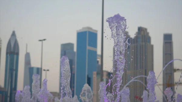 Water fountain. Outdoor fountains. Beautiful splashes of water illuminated from below, the evening. Slow motion