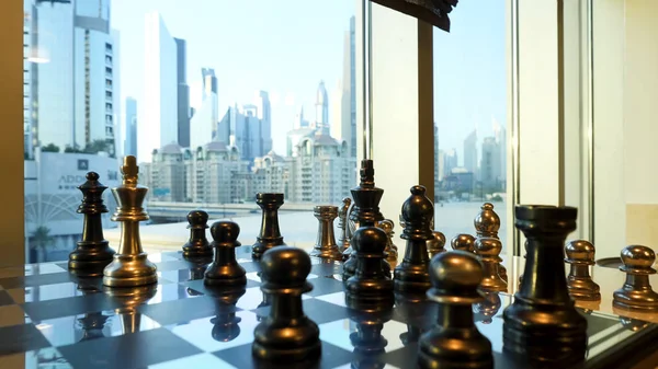 Black and gold chess close up with city landscape with skyscraper background. Business strategic formation in the chess game with city background