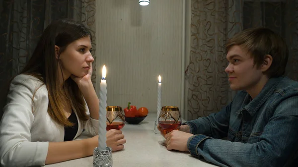 Young couple having romantic dinner with her boyfriend and drinking wine together at home. Girl with a guy on a romantic date at home — Stock Photo, Image