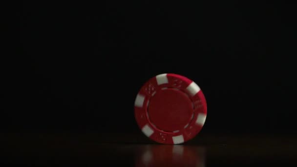 Poker chip spinning on the table. Casino theme. Poker game, poker chips on table, on black background — Stock Video