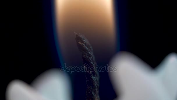 Feche de uma chama de vela em um fundo preto. Vela branca com fundo escuro. Queimando velas em um fundo escuro com luz quente — Vídeo de Stock