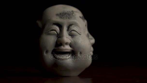 Close up of statuette of smiling, happy face on black background. Black and white figurine of happy face close up. White statuette of happy, smiling face. Closeup of statuette of Joyful face — Stock Video