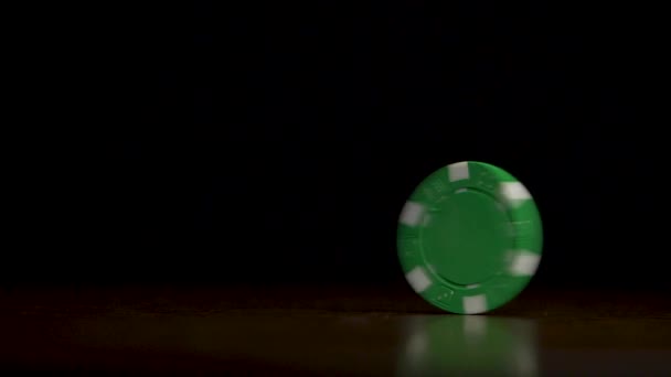 Rotation of poker chips on the table isolated on black background. Poker chips shaffling. Poker chip spinning on the table isolated on dark background — Stock Video