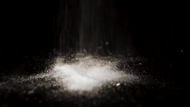 Launched powder, isolated on black background. White powder pours. White powder similar to cocaine spilling on black background, closeup — Stock Video