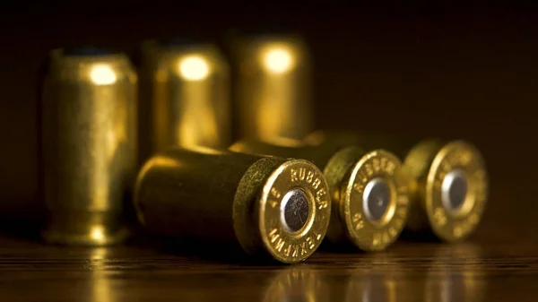 Bullets closeup on black backgrounds. Rubber bullets macro with limited dof on a black background, 9mm full metal jacket. bullet macro with limited dof on a black background