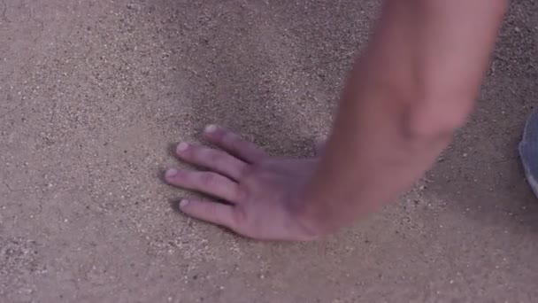 Mans hand touches to their native land. Young man finally home, stooped to the ground to touch it. Concept of native place — Stock Video