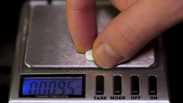 Close up of electronic scales being in use. Laboratory scales. Laboratory worker weighs the manufactured tablets on the control scales. Pills and medication health, close up — Stock Video