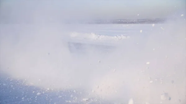 Auto con pneumatici invernali montati su cerchi in lega leggera in strada innevata all'aperto. Una macchina che percorre una strada innevata durante l'inverno. Auto guida su una strada innevata — Foto Stock