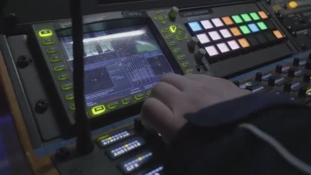 Hand of Technician using Sound system mixing audio equipment board on stage with soft light,selective focus. Mens hands are controlling the console of a large hi-fi system. Sound equipment. — Stock Video
