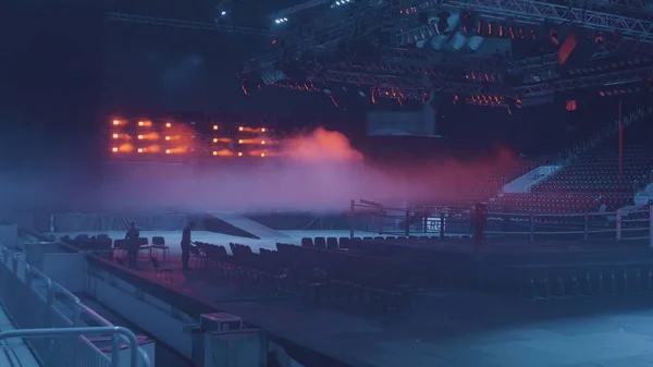 Une vue spectaculaire du coin rouge d'un anneau de boxe ordinaire entouré de cordes éclairées par un projecteur — Photo