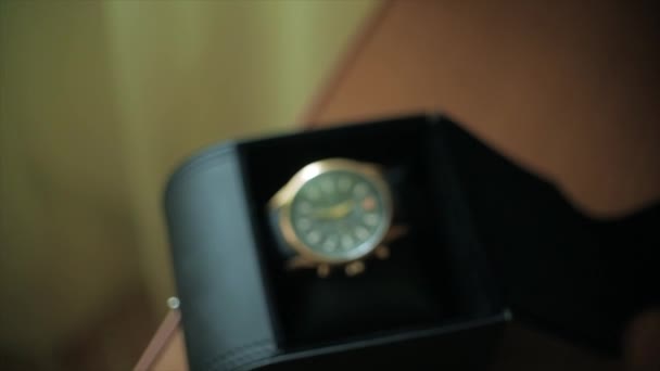 Gentleman accessory. Clip. Close up mens hand taking watch from the box. Concept of business dress