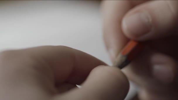 Man nervously twirls a pencil in your hand close up. Close up of hand holding a pencil. Fingers hold a pencil macro shoot. Mans hand holding a pencil to writing on paper