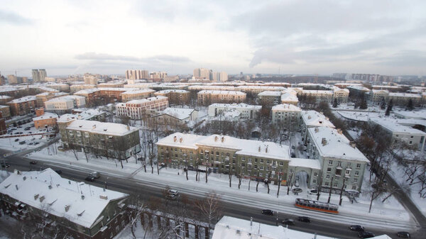 Apartment buildings or blocks of flats covered by snow. Clip. Urban winter landscape with street perspective aerial top view. Clip. The skyscrapers in the city. City life. Amazing city landscape