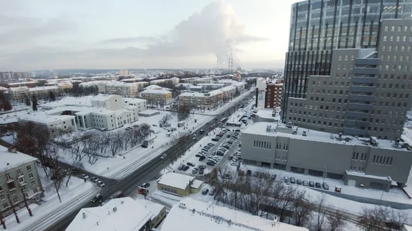 Apartment buildings or blocks of flats covered by snow. Clip. Urban winter landscape with street perspective aerial top view. Clip. The skyscrapers in the city. City life. Amazing city landscape. — Stock Photo, Image