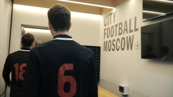 Soccer players in the locker room. Clip. Football team in the locker room. Team is preparing for a football match in the locker room