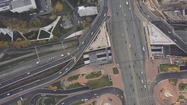 Top view city traffic of highway, logistics. Clip. Aerial top view of road junction from above, automobile traffic and jam of many cars, transportation concept