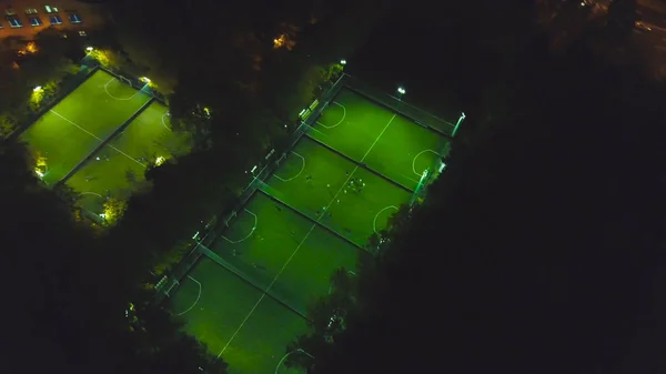 Footbal soccer field night aerial. Clip. Birds eye view of a soccer football court. Top view of the football field at night