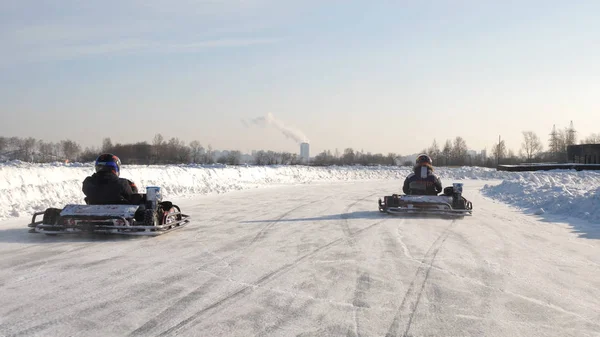 Winter competitions of kart racing on the ice of road. Go kart in winter