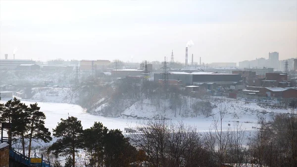 View of city industrial zone, winter evening, gray sky strong wind. View at the grey industrial city