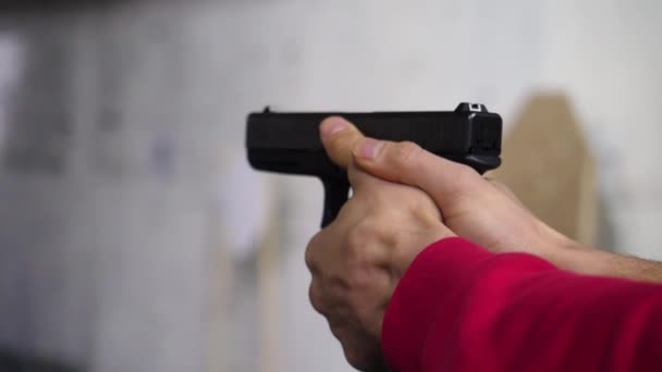 Gun in the mans hand. Man holding a gun close-up. Black handgun in hand of a man — Stock Video