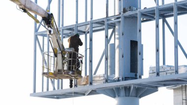 Duvardaki bir reklam afişi için çelik yapı. şantiye ve boş billboard ve mavi gökyüzü