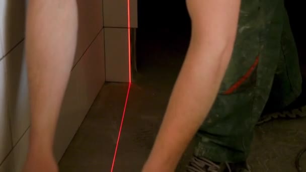 Man hands measuring with laser level gauge. Laser level gauge light. man with laser level check floor and walls — Stock Video