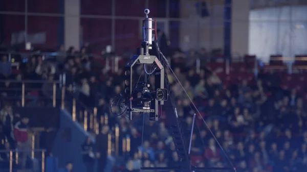 Video camera on a crane at concert, equipment film. camera record on crane in production on studio and light to stage for entertainment industry. TV camera on a crane, football mach or concert