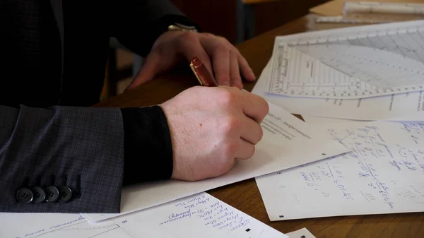 Affärsman som arbetar med dokument på kontoret. Närbild av ung affärsman använder kalkylatorn i Office — Stockfoto