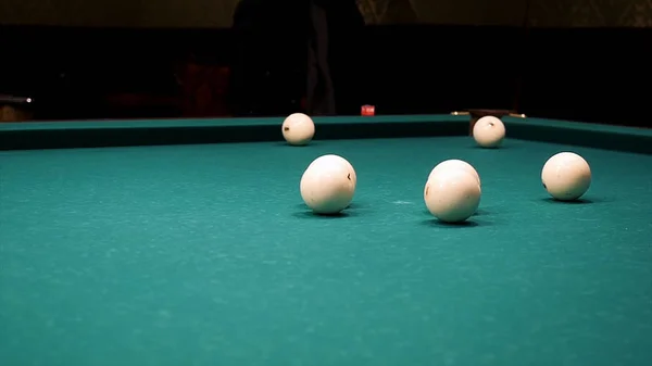 Balls of different number, type, diameter, color, and pattern on a billiard table, billiards table, or pool table covered with green cloth. Balls on a billiard table. White snooker ball on the pool — Stock Photo, Image